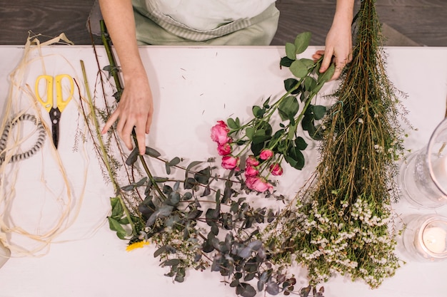 Florist preparing flowers for future arrangement