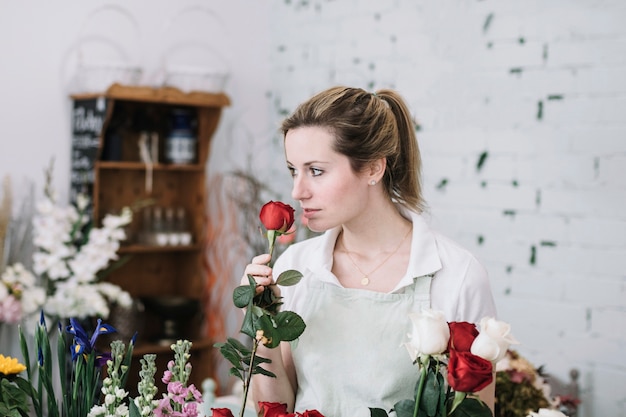 Florist smelling roses for bouquet