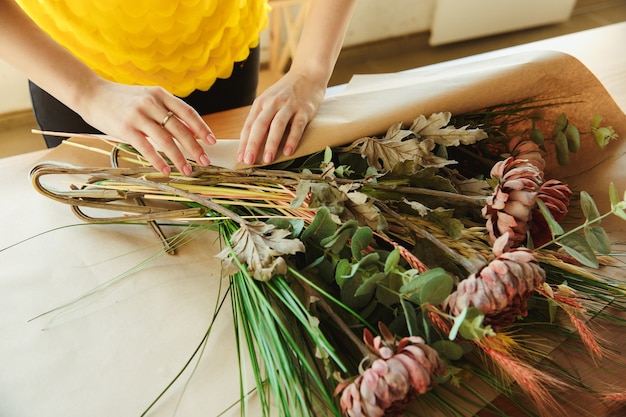 Florist at work shows how to make bouquet