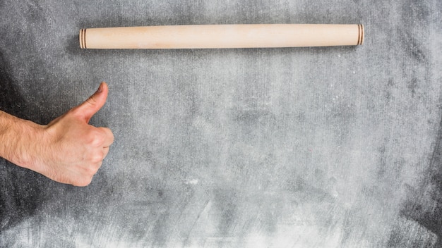 Free photo flour background with rolling pin and hands making ok sign