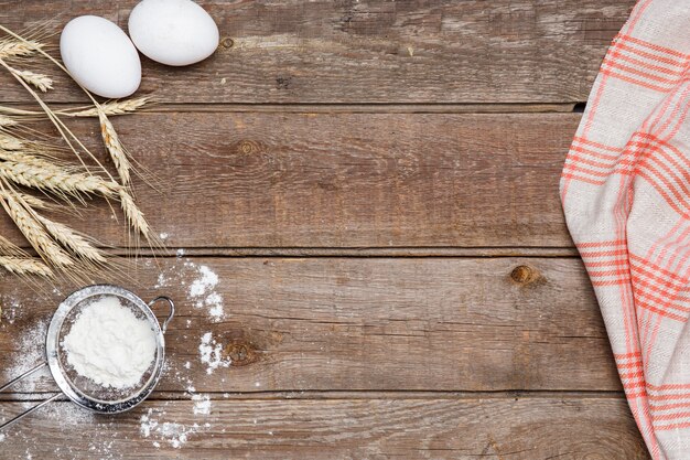 The flour  and eggs on an wooden 