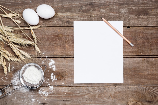 Free photo the flour  and eggs on an wooden