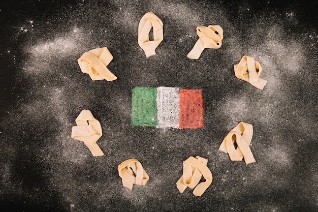 Free photo flour on pasta and italian flag