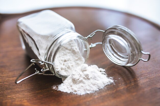 Flour on the table and in a glass jar