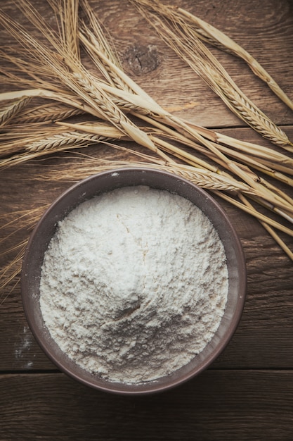 Flour and wheat flat lay on a wooden