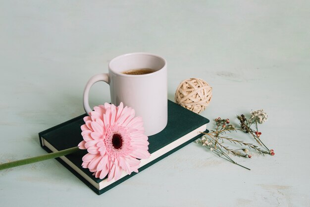 Flower and beverage on notebook