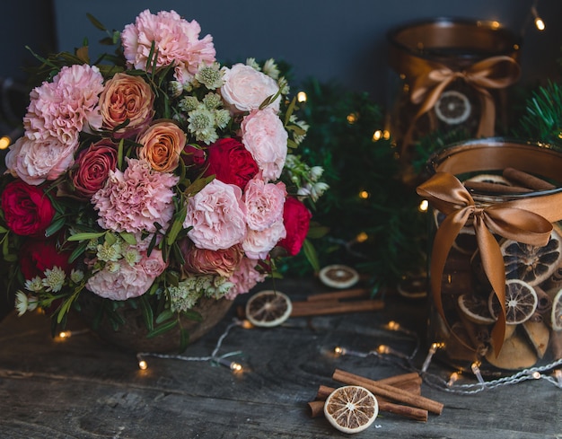Flower bouquet, christmas ligths and cinnamon decoration sticks.