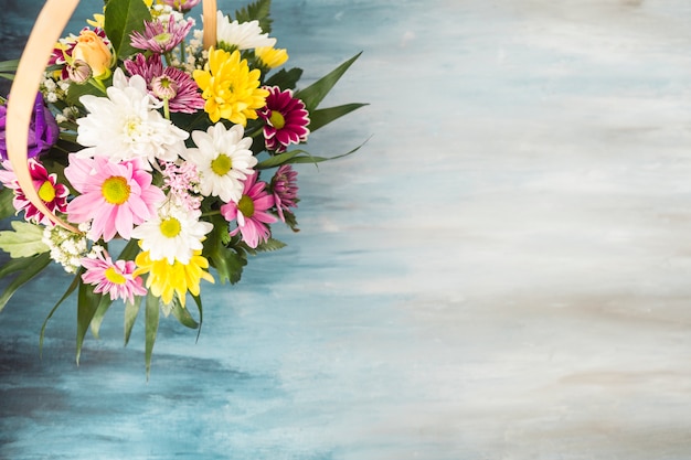 Flower bouquet in wicker basket placed on table 