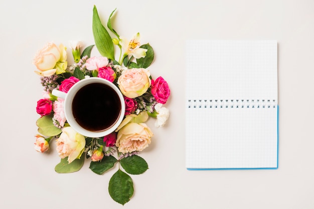 Flower composition and beverage near notebook