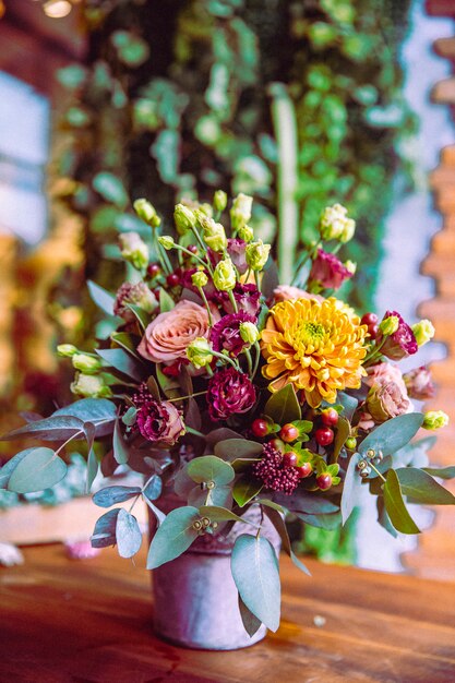 Flower composition in the bucket roses chrysanthemum side view