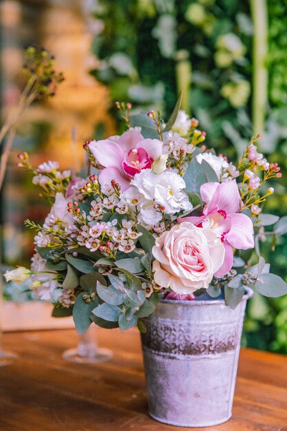 Flower composition in the bucket roses orchid lithianthus side view