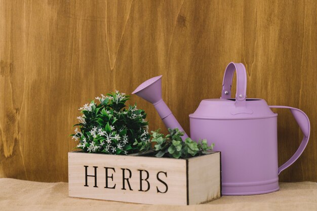Flower composition with herbs and watering can