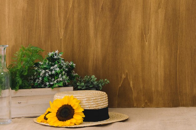 Flower composition with sunflower on hat