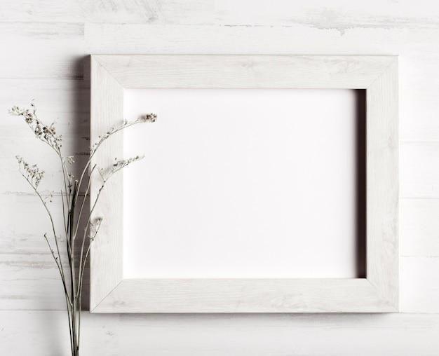 Flower and a frame on wooden wall