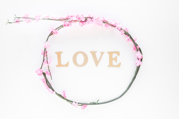 Free photo flower wreath around love writing