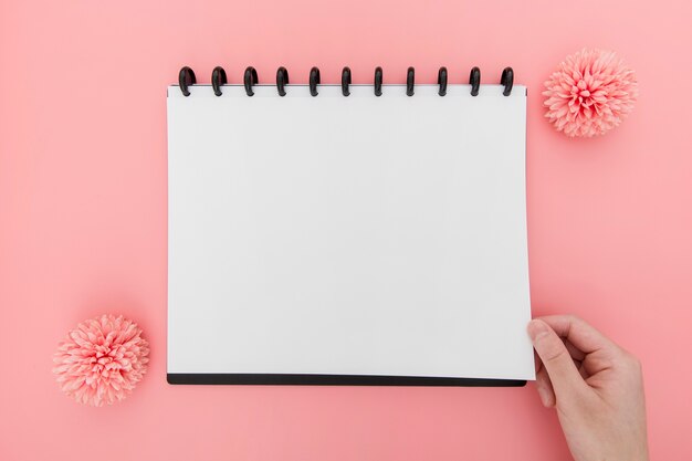 Flowers beside notebook