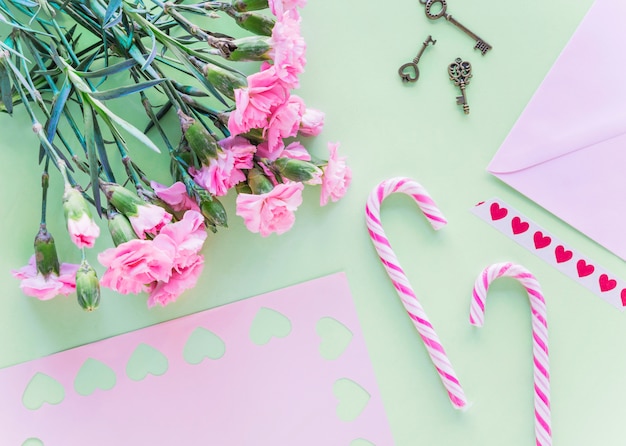 Flowers bouquet with candy canes on table 