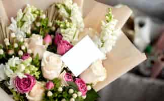 Foto gratuita bouquet di fiori con nota vuota