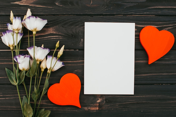 Free Photo flowers bouquet with paper and hearts on table
