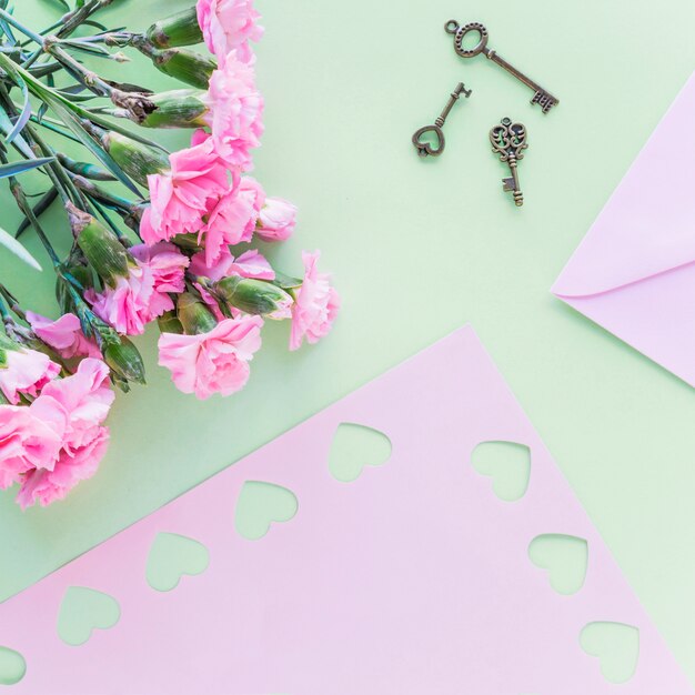 Flowers bouquet with small keys on table 