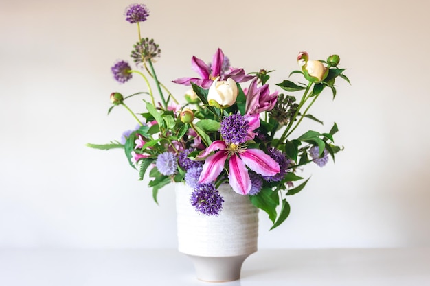 Flowers from a home garden in a vase on a white background