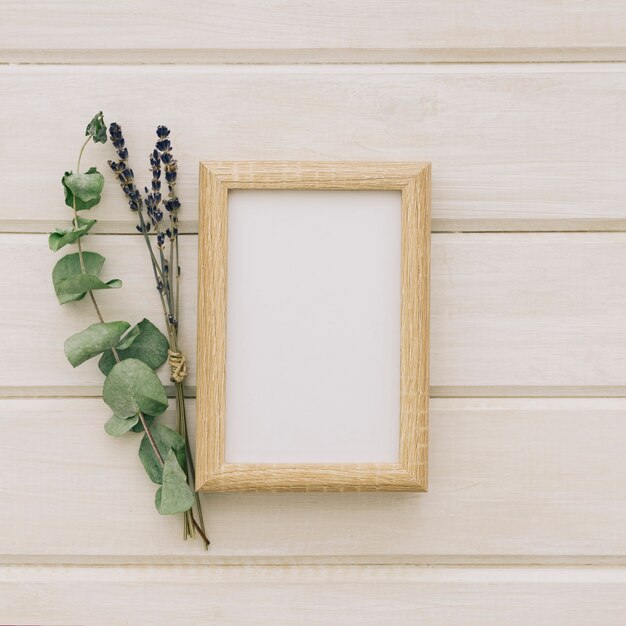 Flowers, leaves and wooden frame