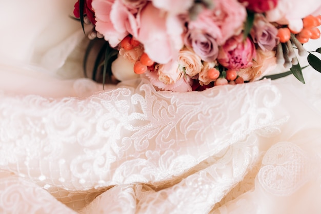 Flowers lie near wedding dress