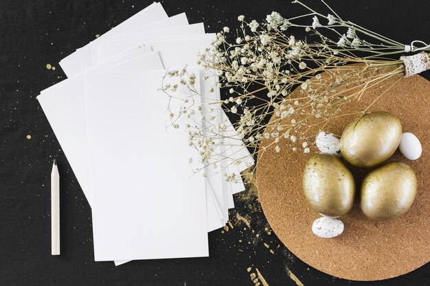 Flowers near eggs and paper