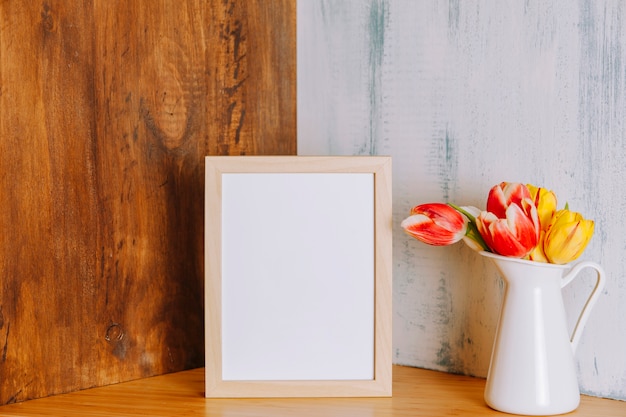 Flowers near frame on shelf