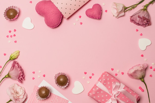 flowers near hearts, present box and chocolate candies