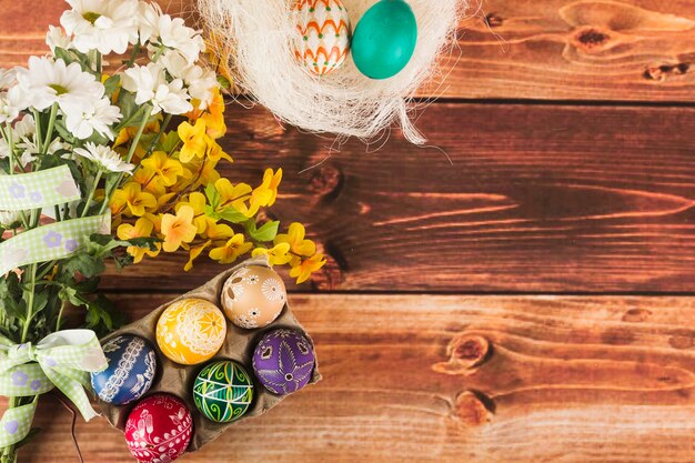 Flowers near nest and egg carton