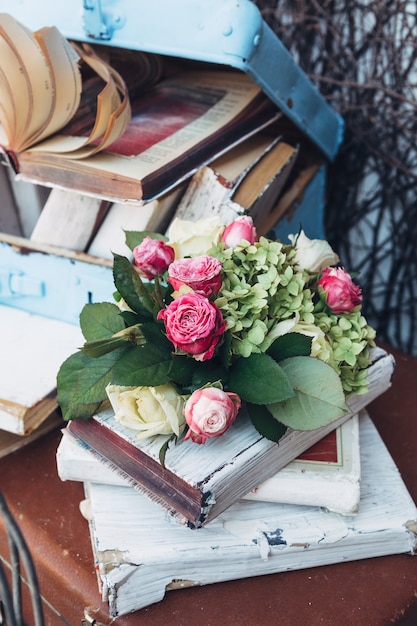 "Flowers old books and suitcases"