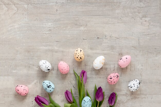 Flowers and painted eggs on table