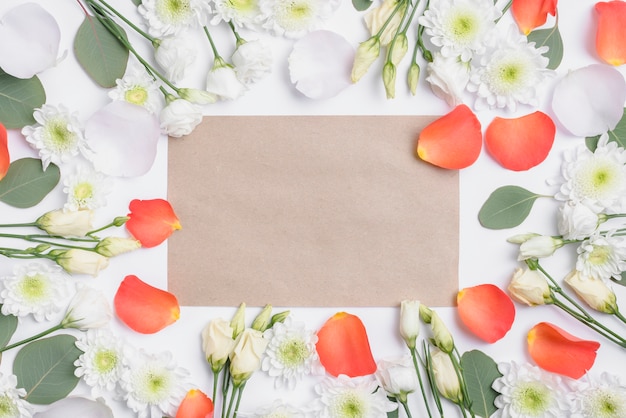 Free photo flowers and petals around paper