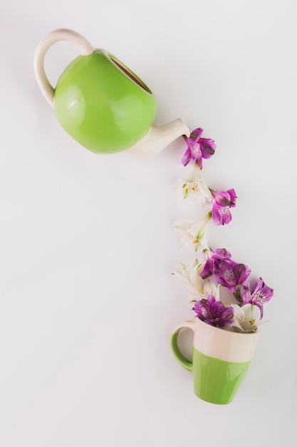 Flowers poring into cup