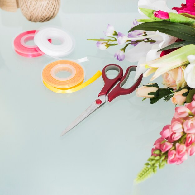 Flowers; scissors and ribbons on desk