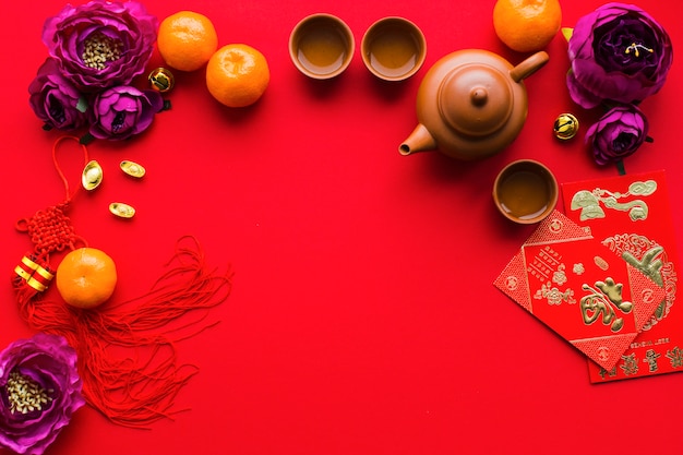 Flowers and tangerines near tea ceremony supplies