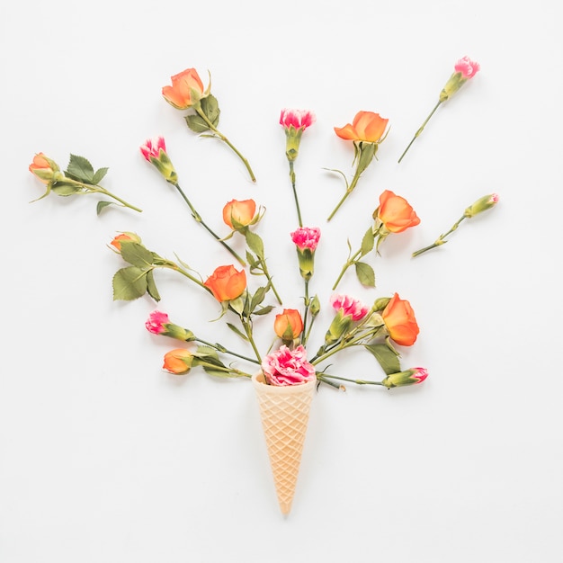 Free photo flowers in waffle cone on table