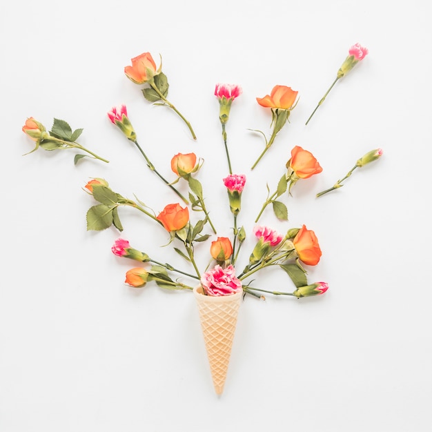 Flowers in waffle cone on table