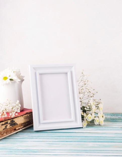 Flowers with blank frame and book 