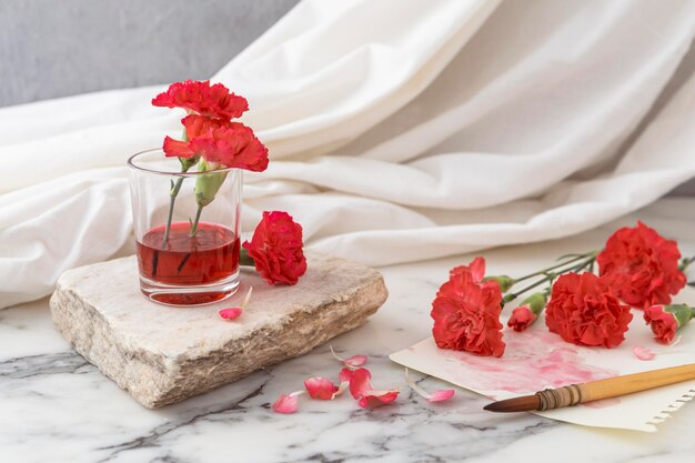 Flowers with glass beside