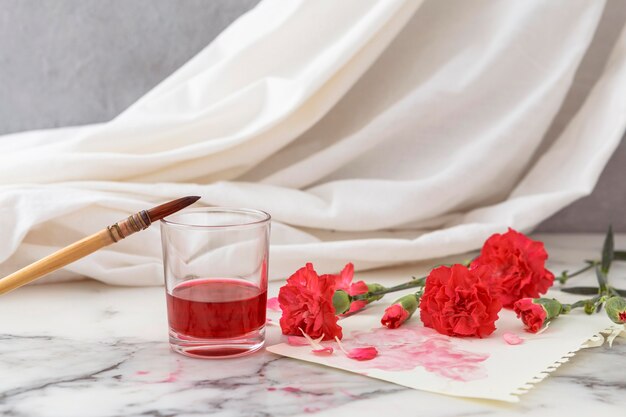 Flowers with glass beside