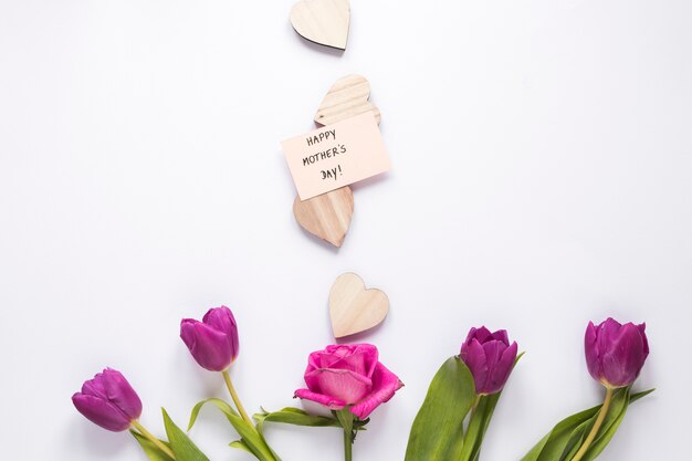 Flowers with Happy Mothers Day inscription and hearts 