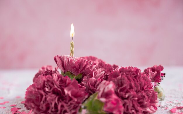 Flowers with lit candle
