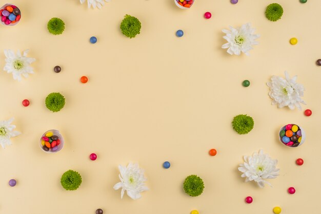 Flowers with small candies on table