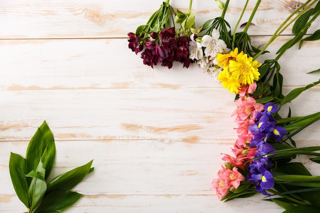 Flowers over wood background From above