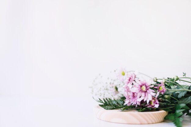 Flowers on wooden plate