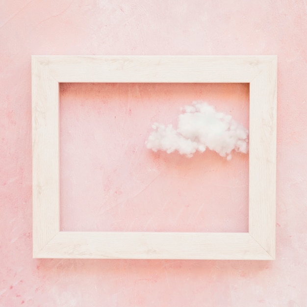 Fluffy cloud in frame outline against painted wall