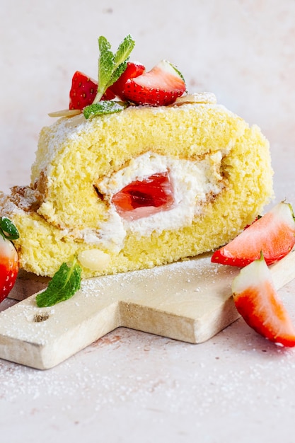 Free photo fluffy strawberry swiss roll food photography