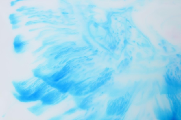 Fluid art. blue ink dissolved in water. abstract formed by color dissolving in water